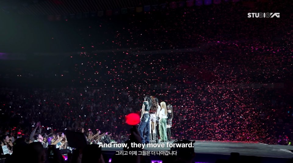 BABYMONSTER members on stage facing a packed audience of global MONSTIEZ during the Hello Monsters North American tour
