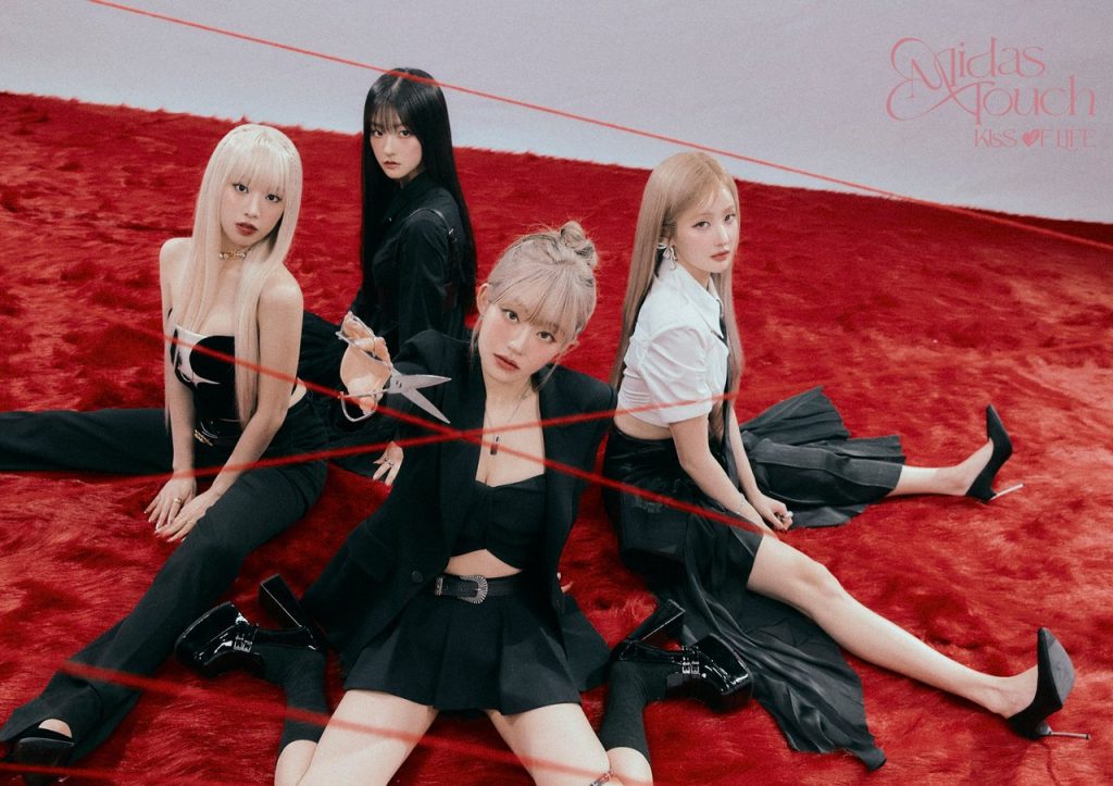 KISS OF LIFE Midas Touch concept photo featuring all four members in black outfits with red string on a red carpet