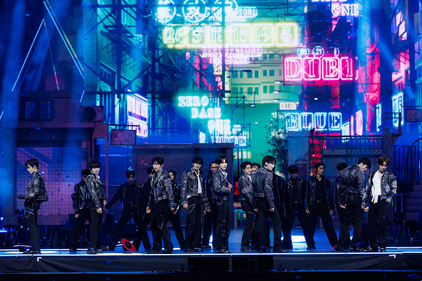 The nine members of ZEROBASEONE lined up on the street-concept stage of 〈HERE & NOW〉
