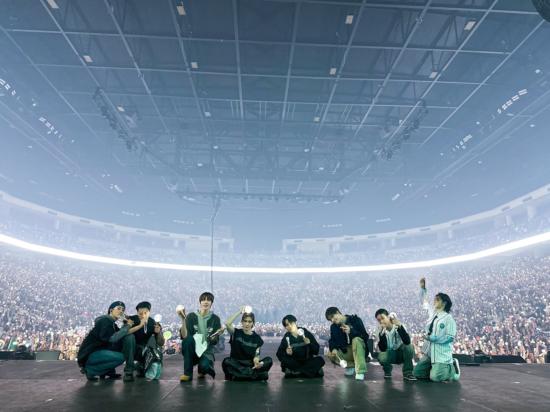 ATEEZ on an arena stage in front of the ATINY fandom during a world tour