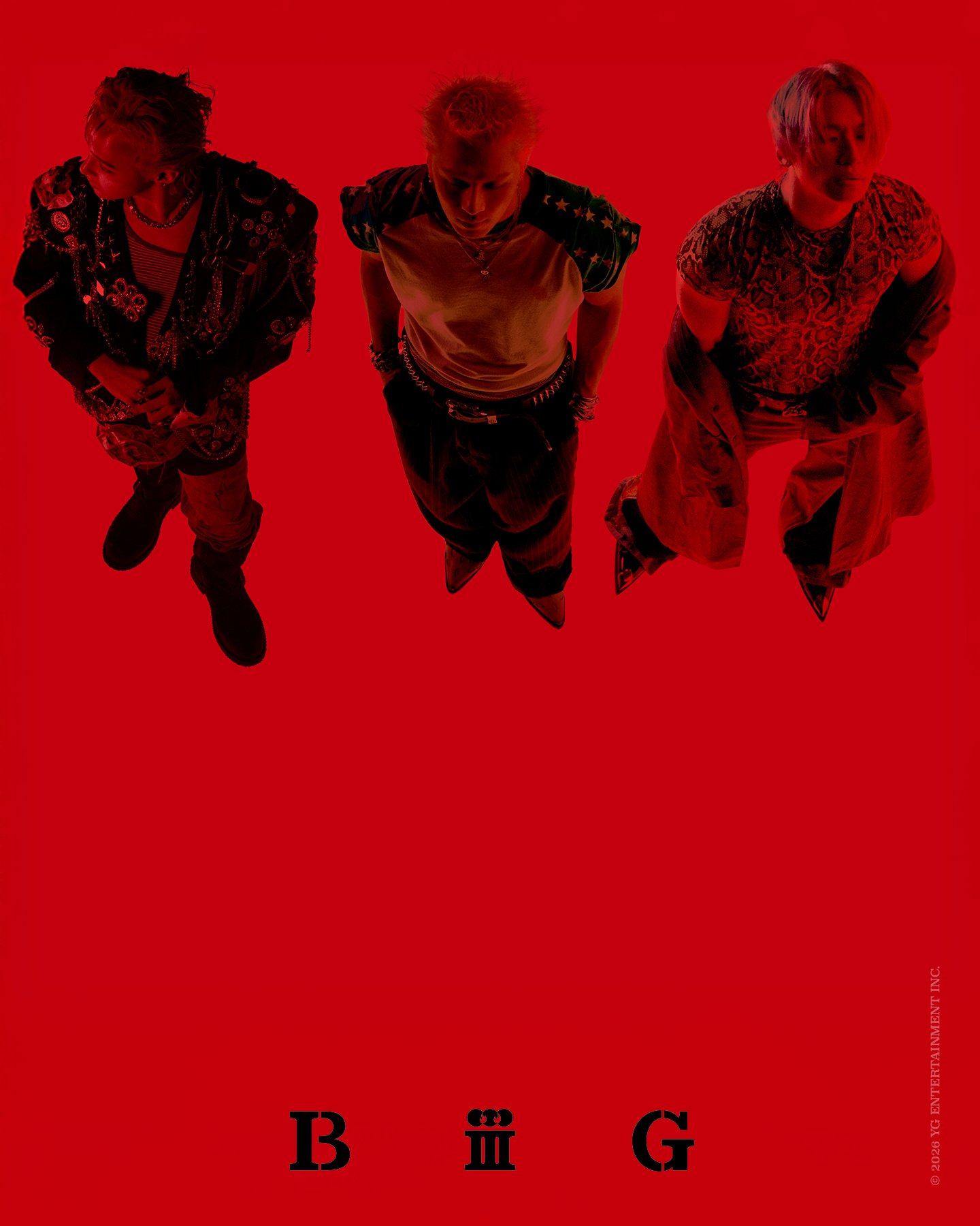 Overhead group shot of BIGBANG's three members against a red backdrop