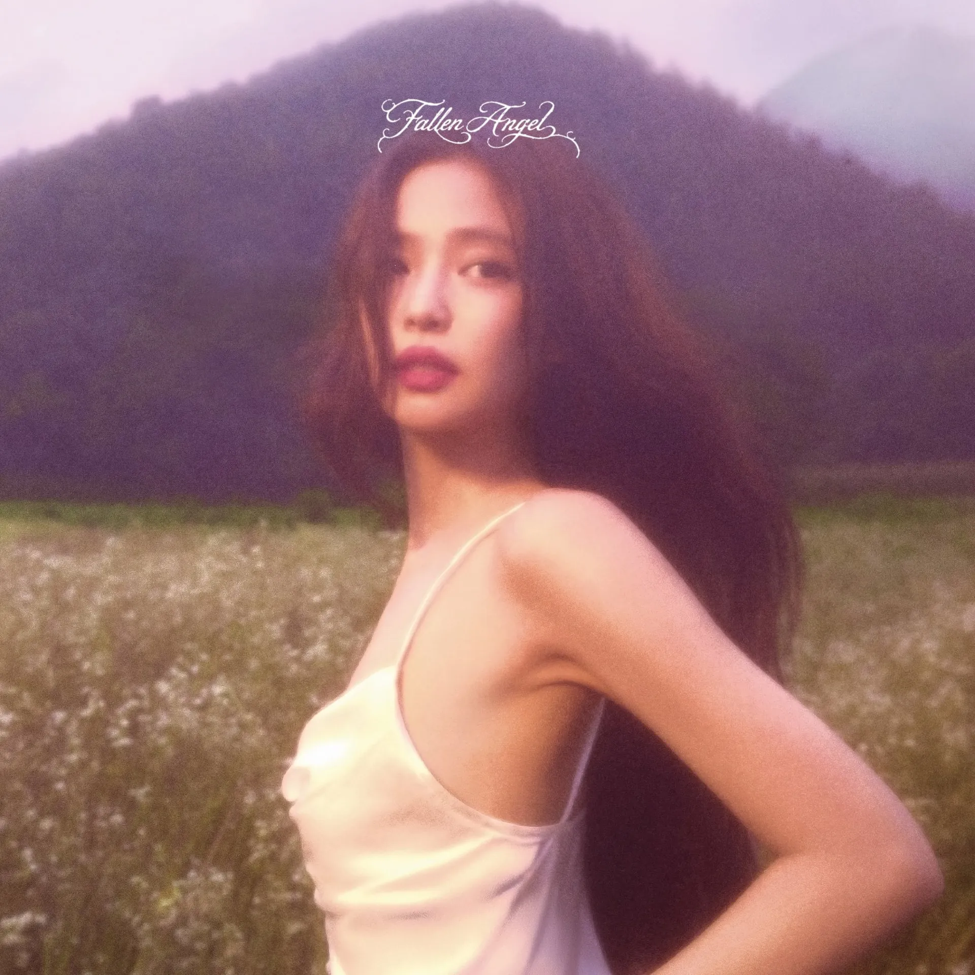 JENNIE standing in an open field in the official concept photo for her 2026 EP Fallen Angel