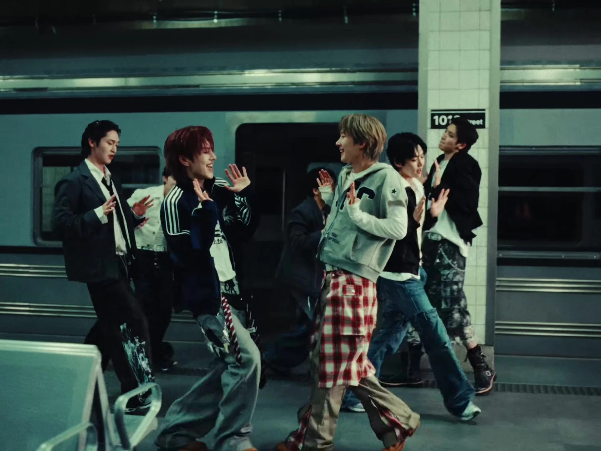 PENTAGON performing the choreography of Coward on a subway platform set